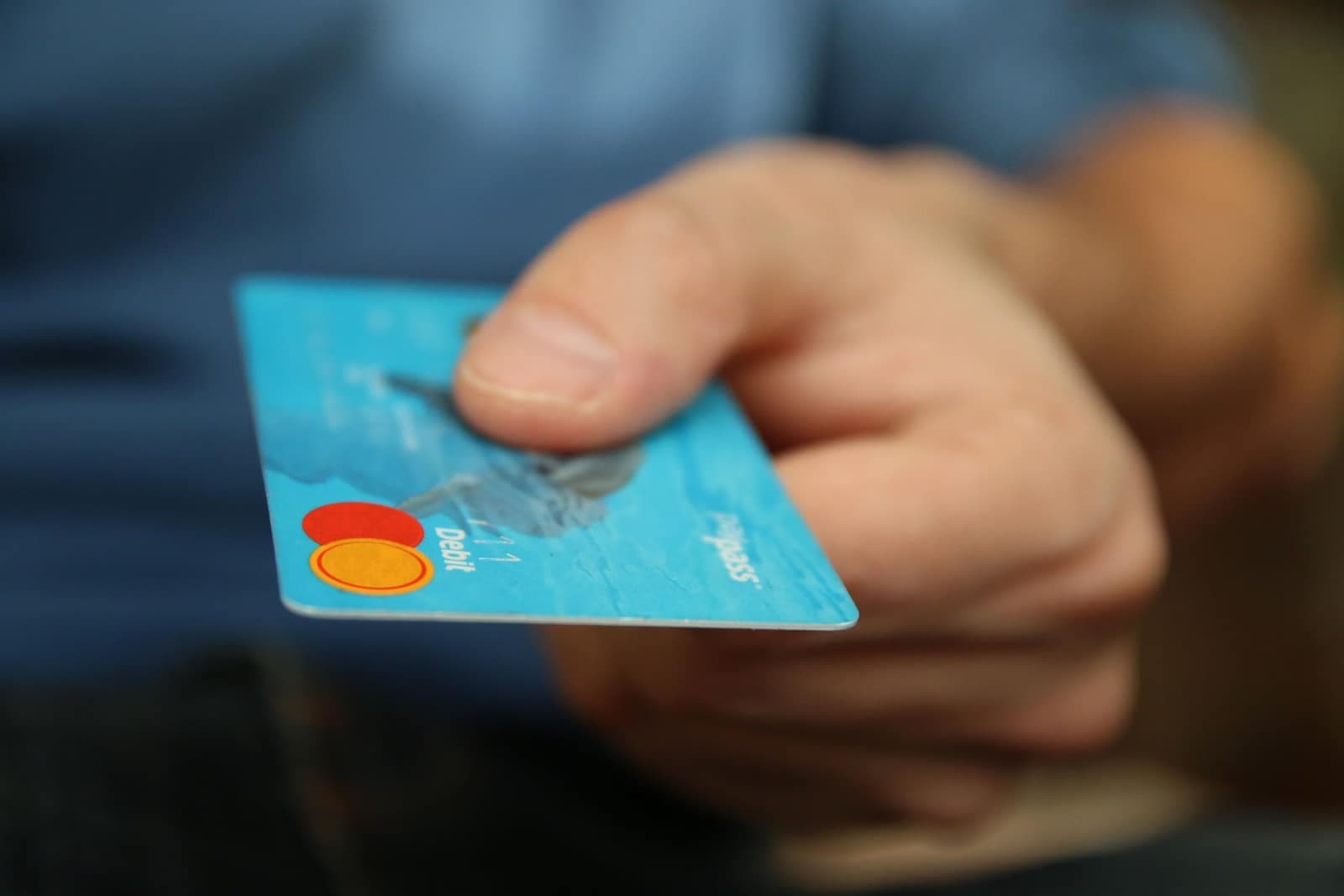 Handing over a bank card to pay