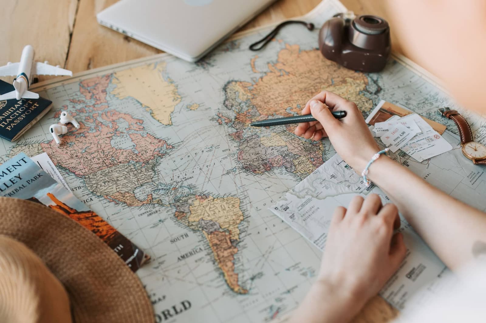 Traveller planning a route on a world map