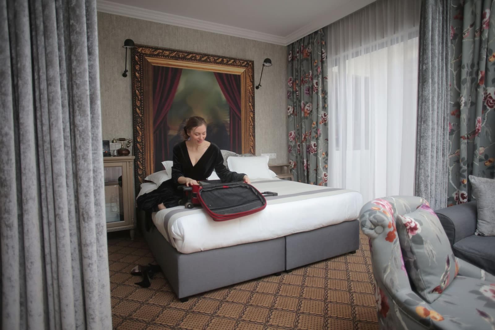 Traveller packing a suitcase in a hotel room