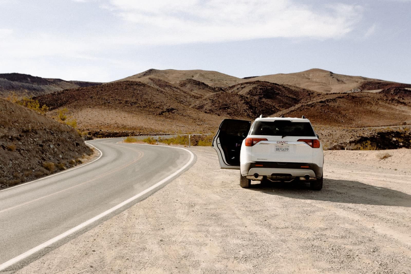 Car parked by a desert road